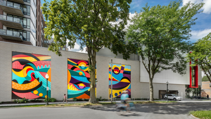 Three murals displayed on the side of the Madison Youth Arts center