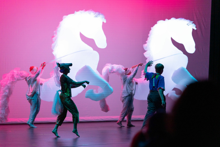 Performers carrying inflatable horses at the Madison Youth Arts center