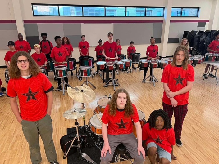 Black Star Drum Line members posing with their drums at the Madison Youth Arts center