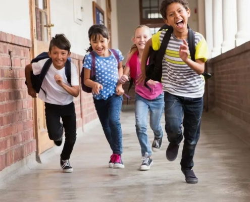 Kids running excitedly down a hallway