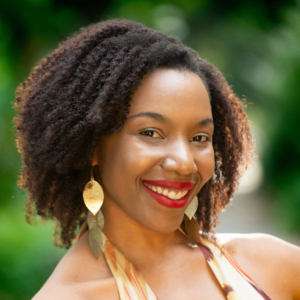 Photo of Onome: a headshot of a smiling black woman looking straight into the camera.